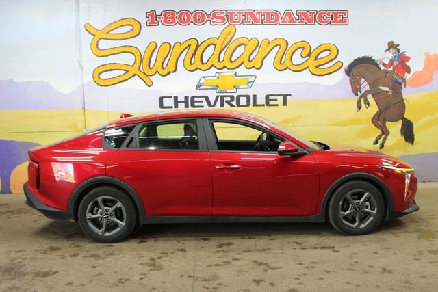 2025 Kia K4 LXS in Red — front three-quarter view