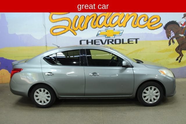 2014 Nissan Versa 1.6 SV in Silver — front three-quarter view