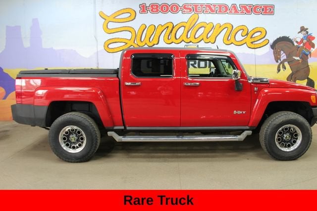 2009 HUMMER H3 H3T in Victory Red — front three-quarter view